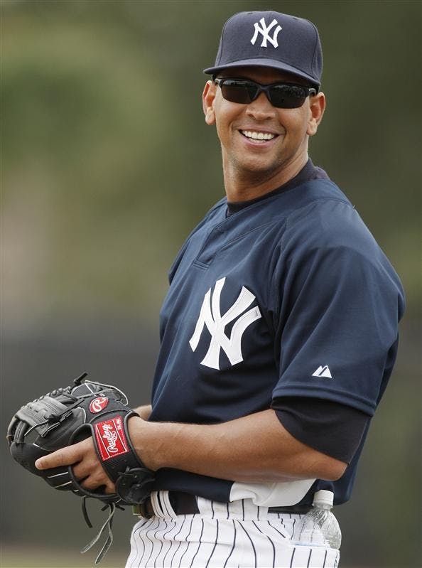 In this February 2008 file photo, New York Yankees third baseman Alex Rodriguez glances back at fans while warming up during spring training baseball workouts in Tampa, Fla.