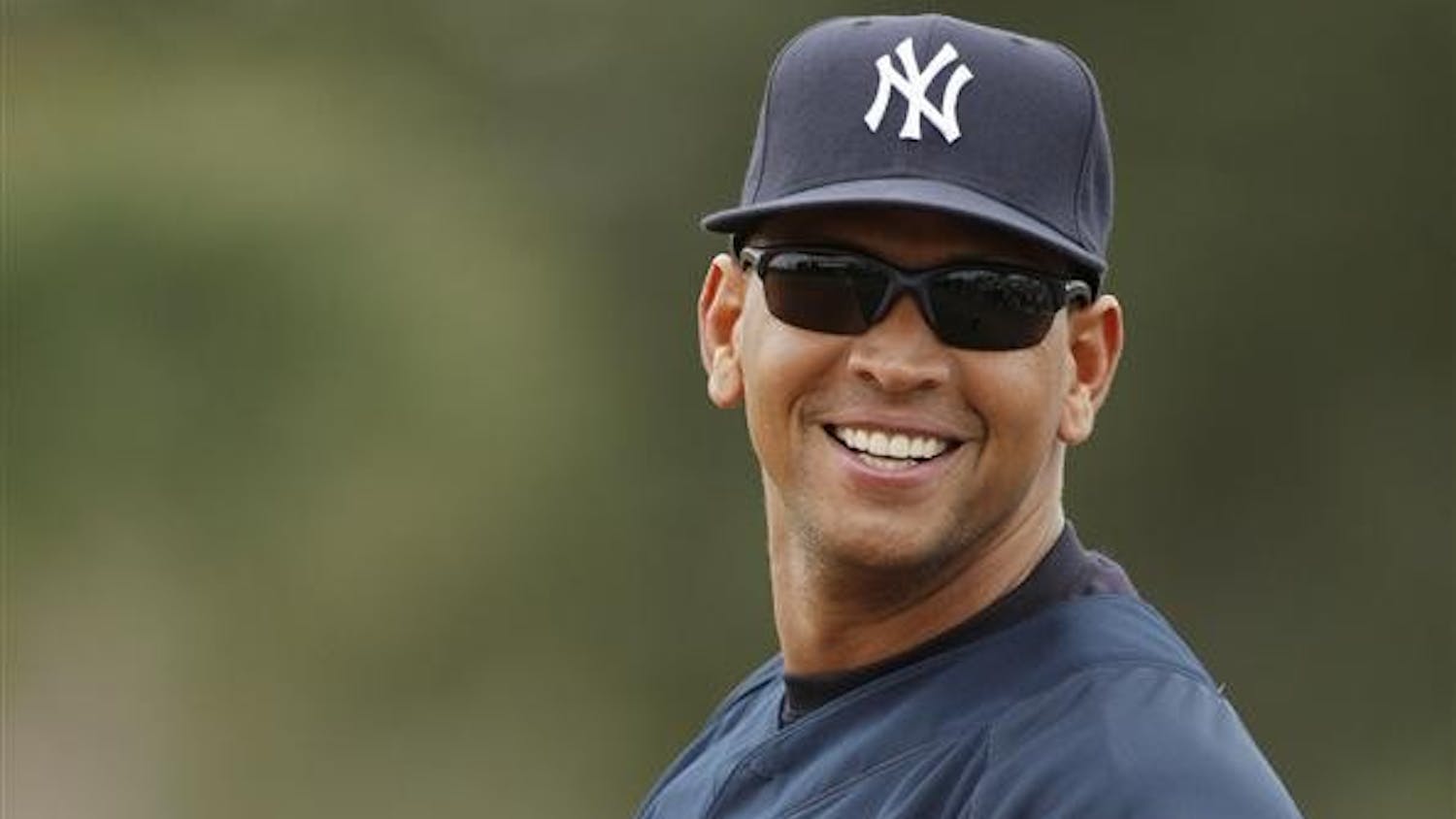 In this February 2008 file photo, New York Yankees third baseman Alex Rodriguez glances back at fans while warming up during spring training baseball workouts in Tampa, Fla.