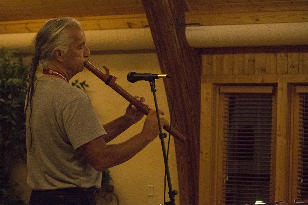 Kevin Locke plays indigenous flute songs during a performance for the Supporting Native Voices Gala on Thursday night at Deer Park Manor. The gala was put on by the Language Conservancy to help conserve ancient languages.
