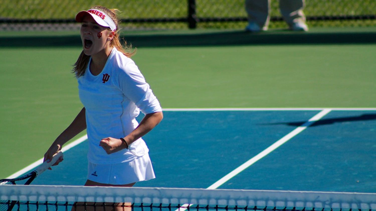 Sophomore Natalie Whalen cheers after scoring a point in a doubles match against Illinois Friday afternoon. The Hoosiers fell against the Fighting Illini., 6-1. 