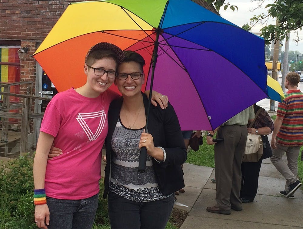 Sarah Perfetti, right poses with her wife Abby Perfetti during a celebration of the Supreme Court ruling in favor of same-sex marriage at Rachael's Cafe on Friday.  They celebrated their one-year anniversary Thursday.