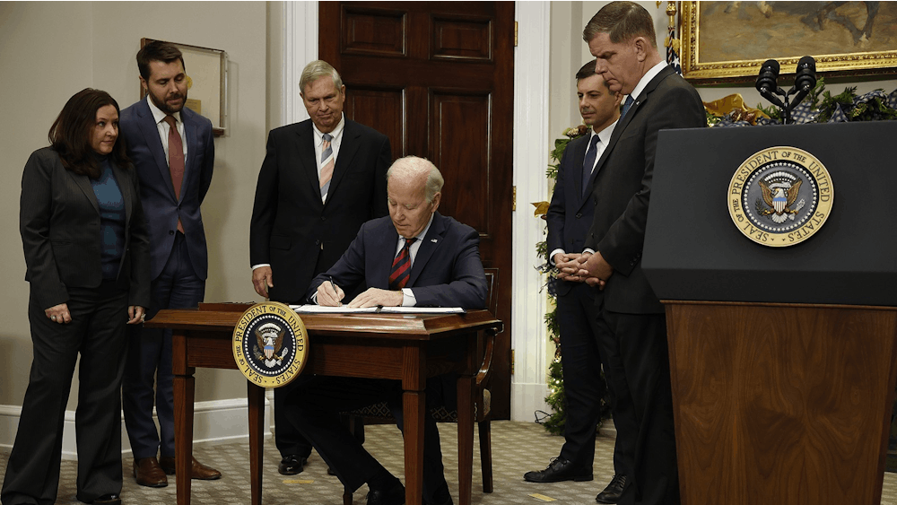 President Joe Biden signs bipartisan legislation averting a rail worker strike Dec. 2, 2022, in the Roosevelt Room at the White House. 