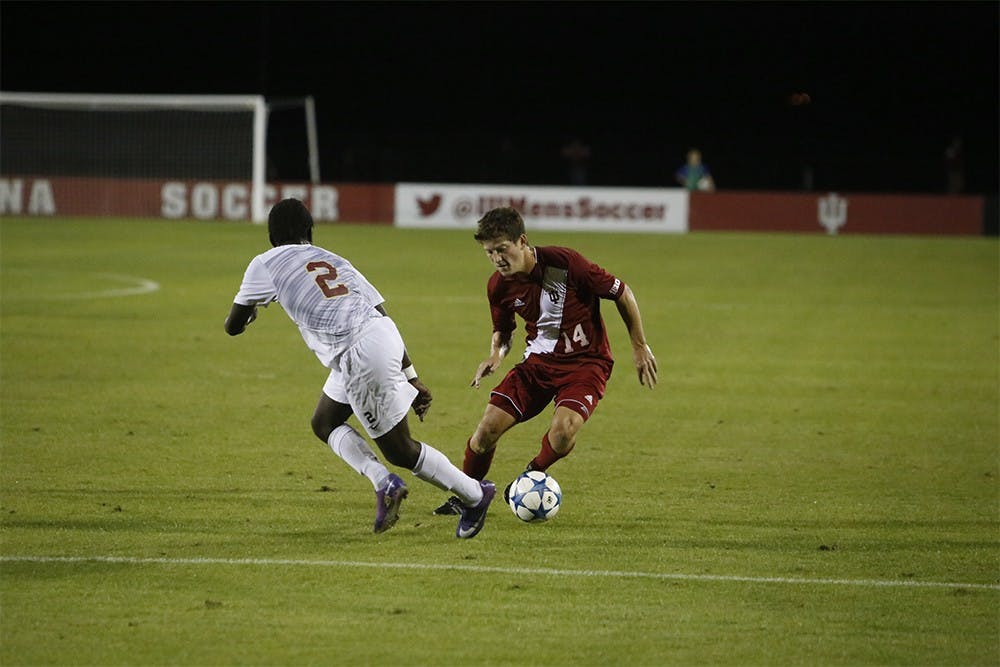 Junior Defender Phil Fives fights for the ball during IU's game against IUPUI Wednesday night at the Bill Armstrong Stadium. IU won 4-0.