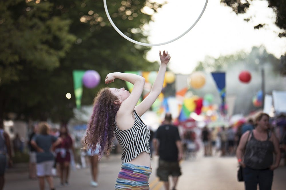 Willow Hughes hula hoops on Kirkwood Saturday night at the Bloomington Pride festival. Hughes is a native of Bloomington and works as a hula hooper for The Hudsucker Posse, a flow arts collective. 