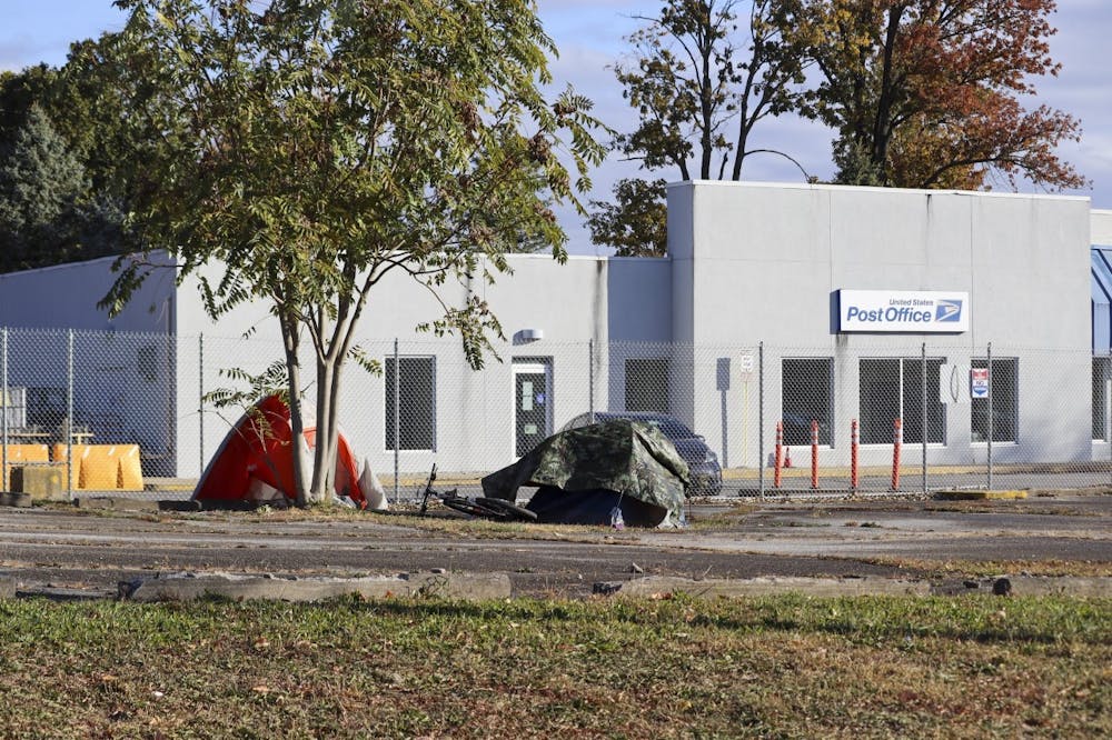 <p>An unhoused camp is seen Oct. 18, 2022, outside the United States Postal Office on South Walnut Street. Homelessness is a policy choice that can be fixed.</p>