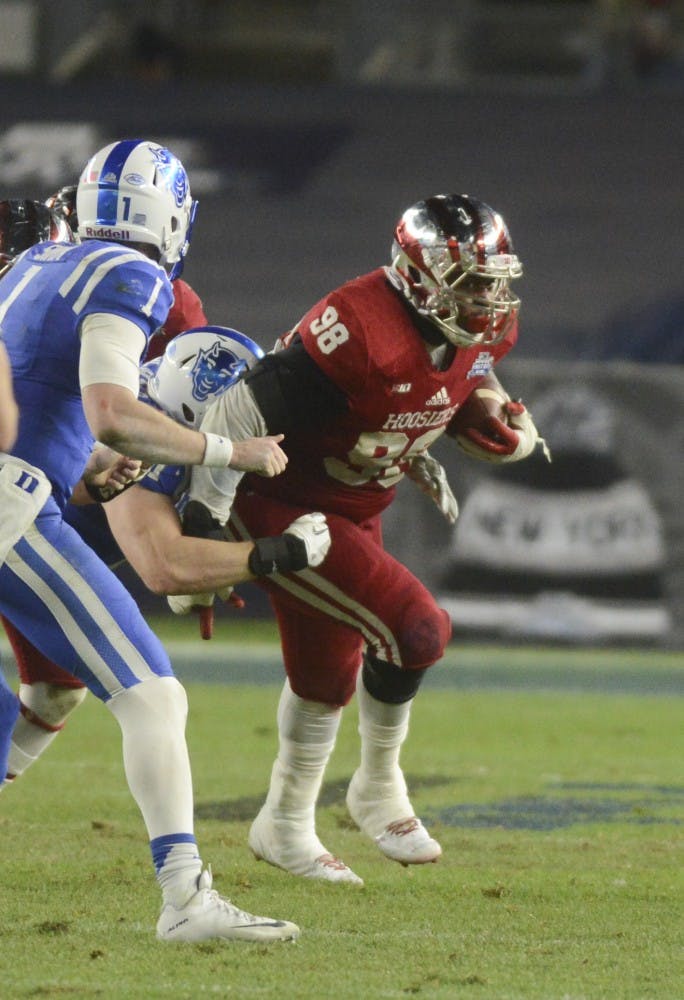 Defensive tackle Darius Latham runs towards the endzone after intercepting the ball during the Pinstripe Bowl against Duke on Dec. 26 at Yankee Stadium.