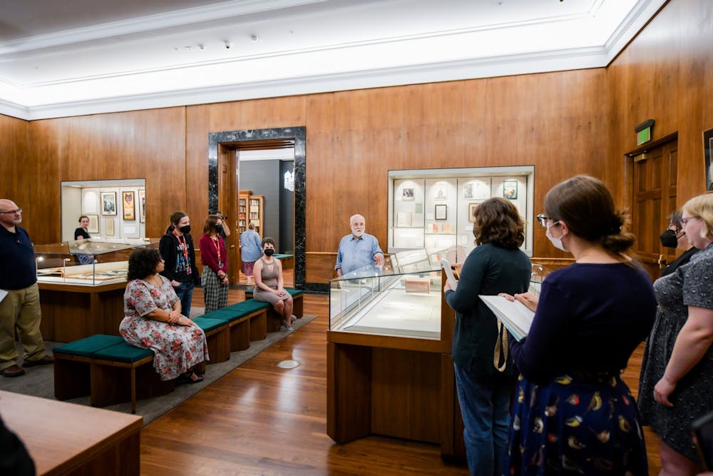 <p>Glen Miranker leads a staff tour of the &quot;Sherlock Holmes in 221 Objects&quot; exhibit in the Lilly Library. Miranker is the collector behind the exhibit.</p>