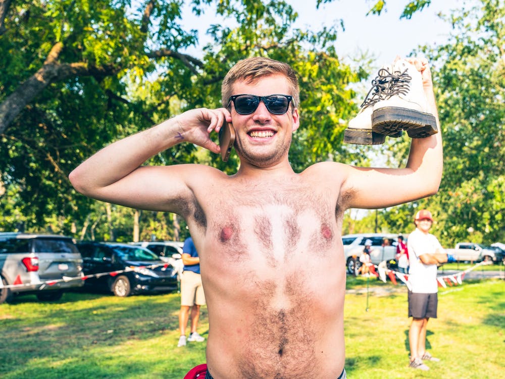 Gabe Seltenright talks on the phone and poses for a picture at a tailgate prior to the Indiana football game against the University of Idaho on Sept. 11, 2021, at the Indiana Tailgate Fields. Saturday was the first time fans could tailgate for a home football during the new season.