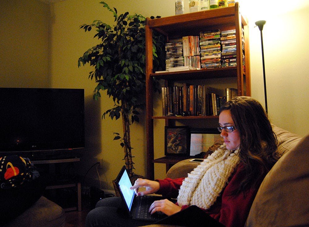 In her apartment, Emily reviews her social work class assignment. She plans to finish her undergraduate degree in the spring and start graduate school in the fall. “I want them to get a glance into my world," she said. "You probably don’t carry your keys with you as a weapon walking to your car.”