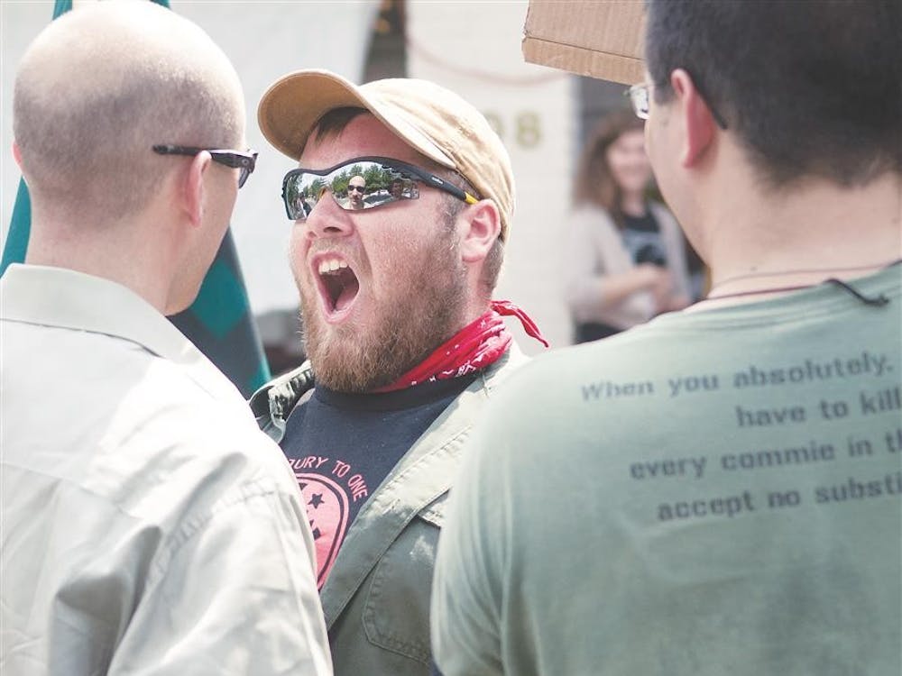 A counterprotester argues with Thomas Buhls on Monday outside of Boxcar Books.
