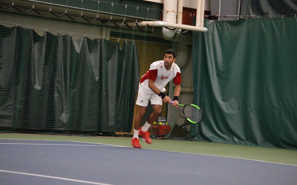 Junior&nbsp;Raheel&nbsp;Manji dives for the ball during the Hoosiers' tennis match against Louisville on Feb. 8. Manji won both his singles and doubles match Thursday, but IU lost in the first round of the Big Ten Tournament to Minnesota.&nbsp;