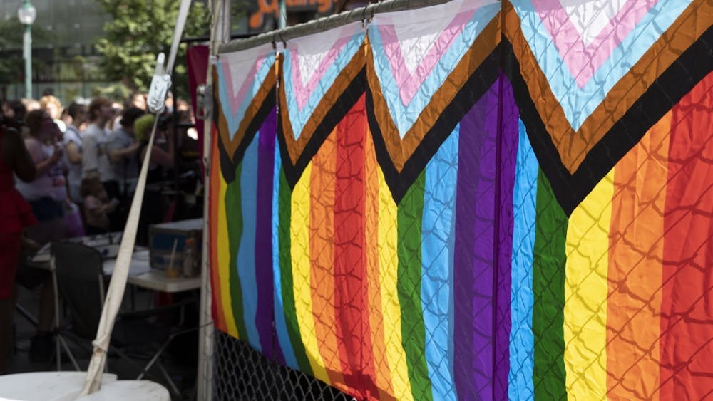 Pride flags are attached to a fence at Pridefest on Aug. 27, 2022. Indiana Gov. Eric Holcomb signed House Bill 1608 into law May 5, 2023. 