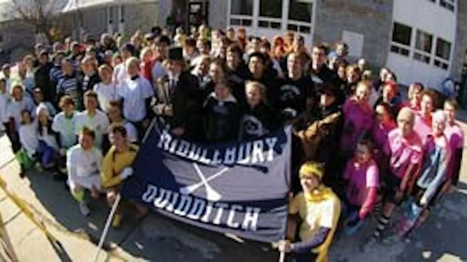 the 12 teams, commissioner, and snitches gather under the banner before marching to the field.