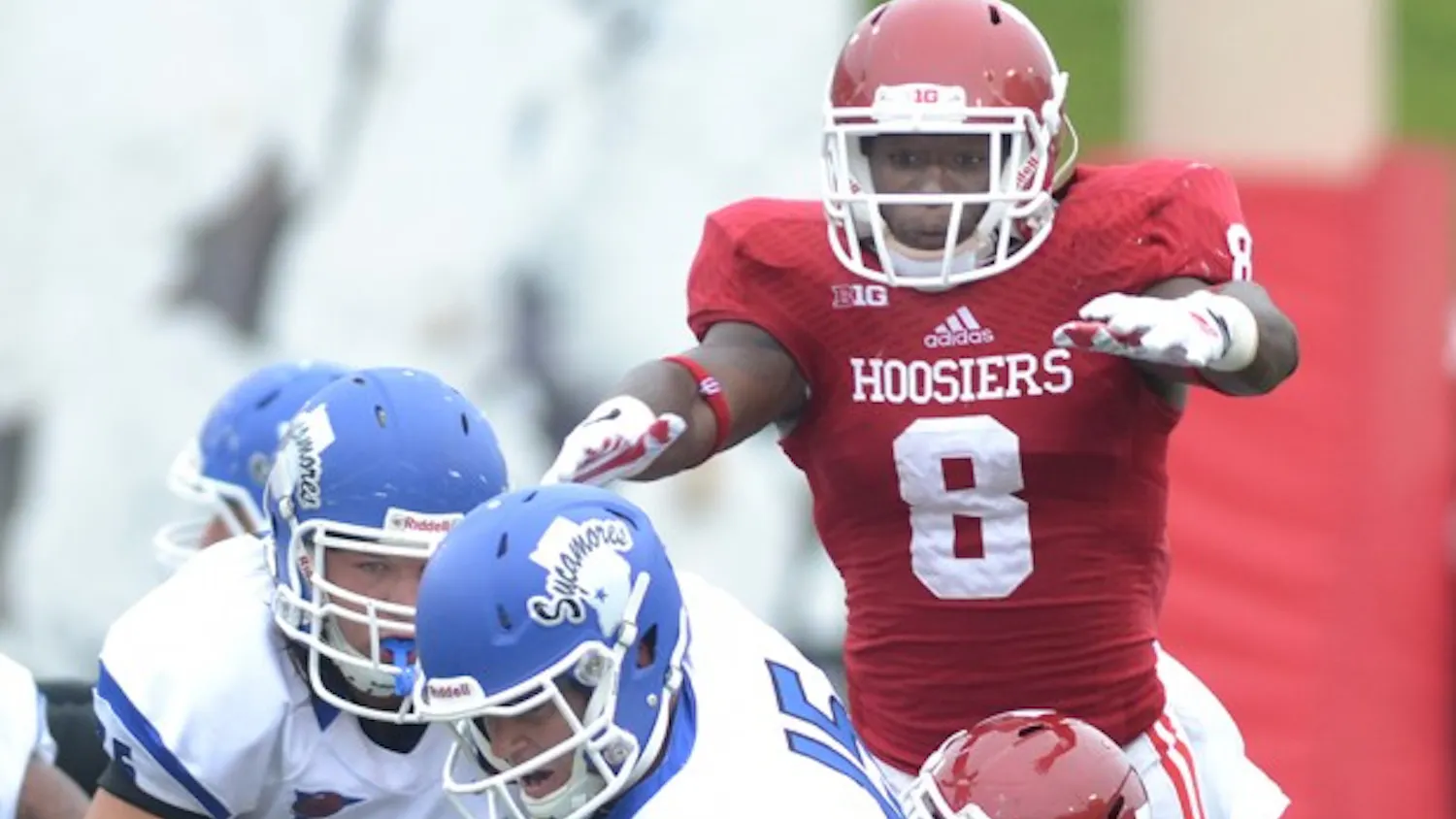 Freshman Tegray Scales jumps over senior Bobby Richardson as they make a tackle in IU's game against Indiana State on Aug. 30 at Memorial Stadium.