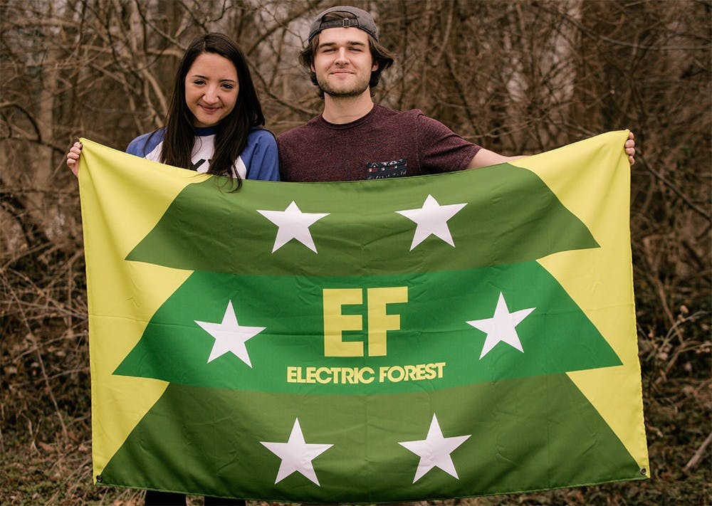 Junior Ashton Moody (left) and sophomore Kendall Noel pose with their flag from the Electric Forest music festivel. Moody and Kendall work during the school year to pay for music festivels during the Summer. This year they plan to return to Elecrtric Forest, which is held in June in Michigan and to attend Coachella, a popular music festivel that is in April held in California. 
