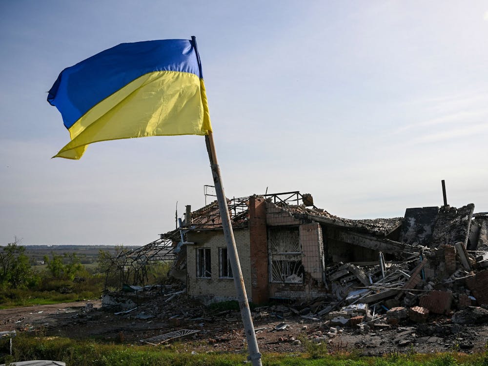 A Ukrainian national flag is displayed in front of a destroyed house Oct. 1, 2022, near Izyum, eastern Ukraine, amid the Russian invasion of Ukraine.