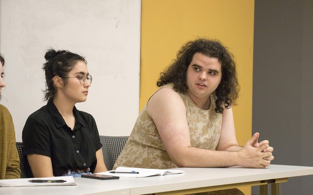 Bee Smale (right), a senior in Policy Analysis and Gender Studies, responds to a question as Anna Ortega (left), a sophomore in History and Folklore, listens. "If 100% of Congress were women, would catcalling still be a thing, would 1 in 5 women on college campuses still be raped?" Smale asked the room. 