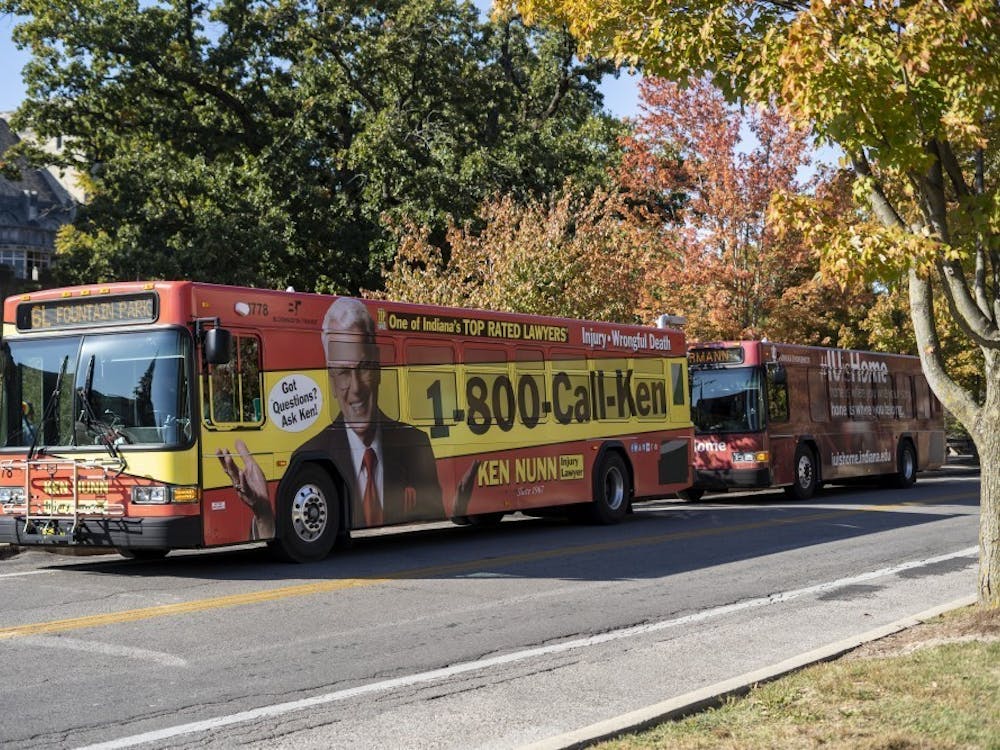 Two Bloomington Transit buses wait to pick up students Oct. 15, 2019, on East Seventh Street. Bloomington Transit has postponed approving all service changes.