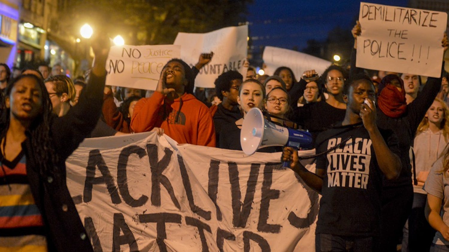 Protesters march to the Bloomington Police Department during the Black Lives Matter protest Monday evening from the sample gates. The event, hosted by Students Against State Violence and the Black Student Union, targeted the Bloomington Police Department because of their failure to bring justice in the 2015 case of Joseph Smedley.