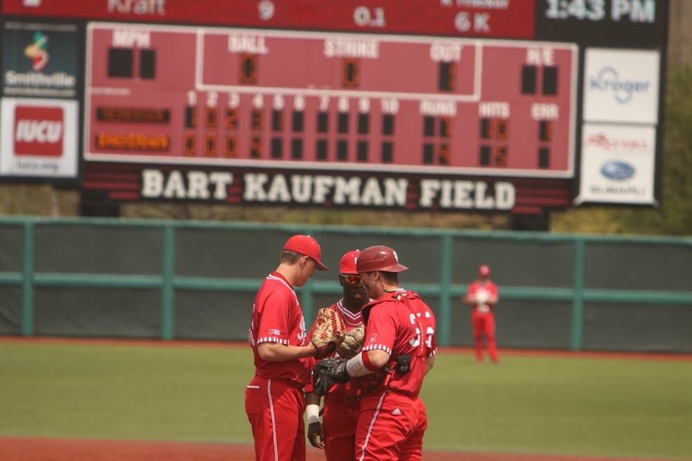 <p>Three IU baseball team members huddle on the field April 24, 2022, at Bart Kaufman Field.  Indiana will play Iowa in a three-game series starting Thursday. </p>