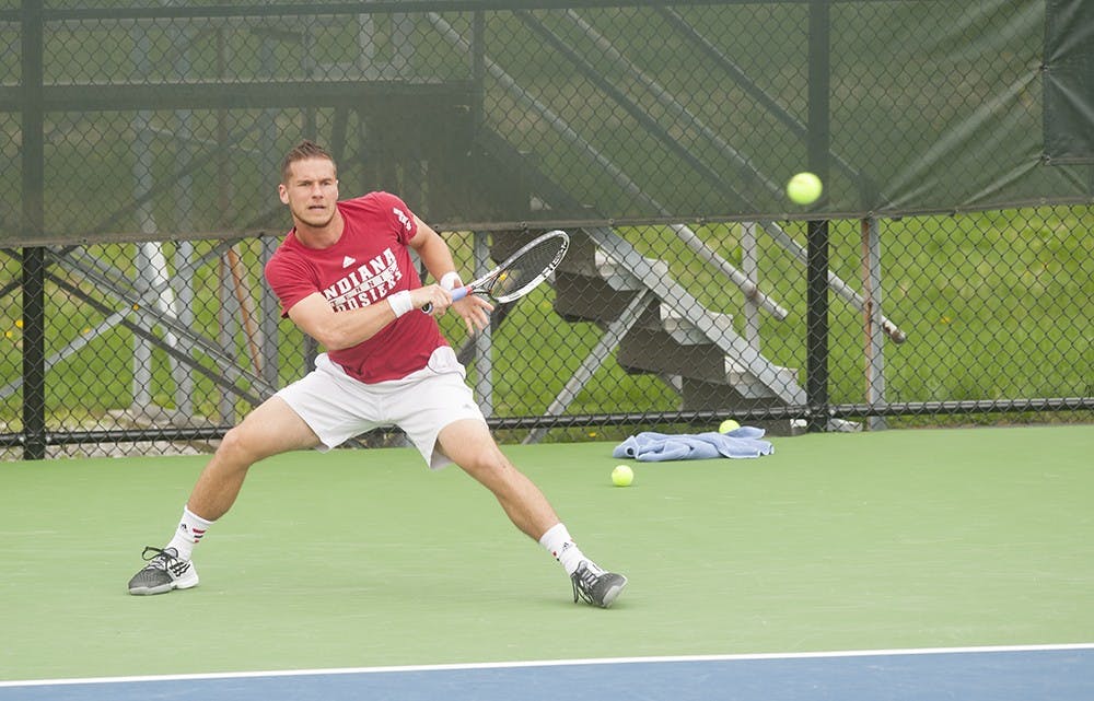 Sven Lalic giving a forehand return against Mateus Silva of Purdue University on Wednesday at the Varsity Tennis Courts. Lalic was trailing 2-6, 2-4 and the match was unfinished.