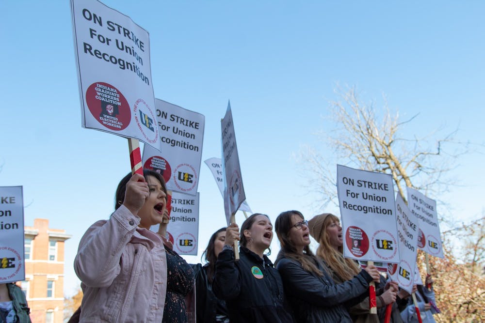 <p>Students holds strike signs and chant in front of the Chemistry Building on April 14, 2022. The IU Board of Trustees said they will not recognize the graduate worker union.</p>