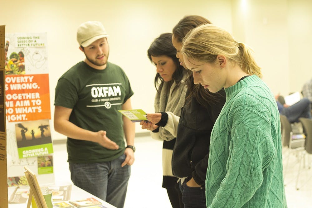 Students check out more information about Oxfam America, a global organization working to right the wrongs of poverty and hunger, while attending its 4th annual hunger banquet Tuesday in the Union Street Auditorium.