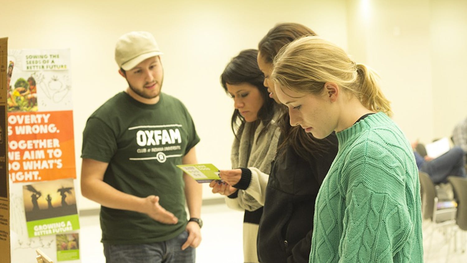 Students check out more information about Oxfam America, a global organization working to right the wrongs of poverty and hunger, while attending its 4th annual hunger banquet Tuesday in the Union Street Auditorium.