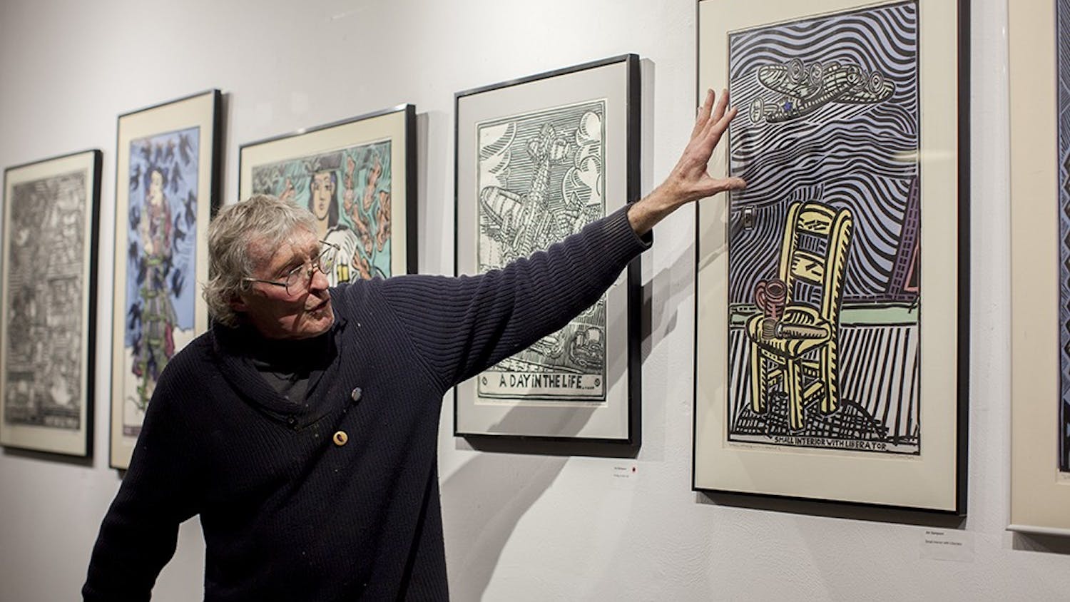 Printmaker Jim Simpson talks about his linocut prints at Blueline Media Productions on Thursday.  His work will be on display until Jan. 30th.