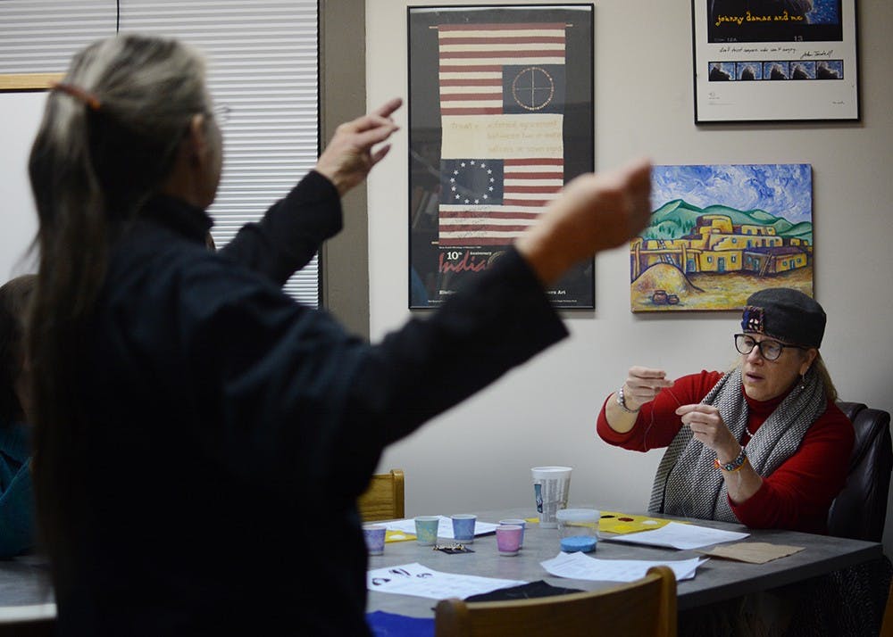 "Liese Hilgeman follows the instructor, Marilyn Cleveland, and makes her own beads earring.  "I've been a supporter (of IU First Nations Educational and Cultural Center) for the past 6 years," Hilgeman said. "I really enjoy creating those beautiful objects." 