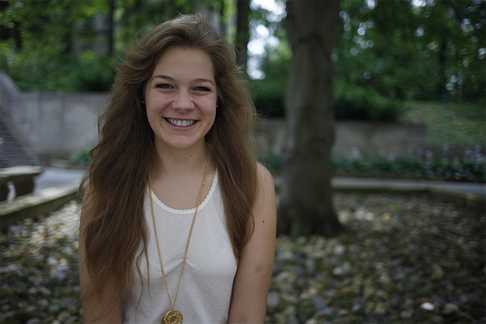 Brianna Holt poses on a bench outside of the room where she performs "Welcome to College" with the New Student Orientation program.  Every year the program puts on a play discussing themes such as sexual assault and self identity that students may experience in college.