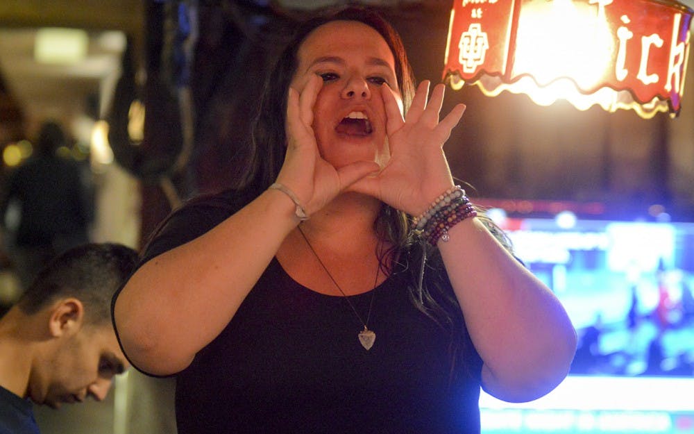 Hillary Clinton Fellow Sydney Ellison shouts from the table tops after the presidential debate Monday night at Nick’s English Hut. The event hosted the democratic side of the debate as Hillary supporters erupted in applause after each one of Hillary’s triumphs.
