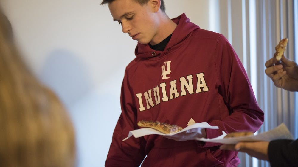 Sophomore Alex Brown eats his last meal of Domino's sausage pizza before fasting for 24 hours. "My eyes have been opened to the fact that slavery still exists," &nbsp;Brown said about Freedom Fast for International Justice Mission. "It's not just a problem from the past."