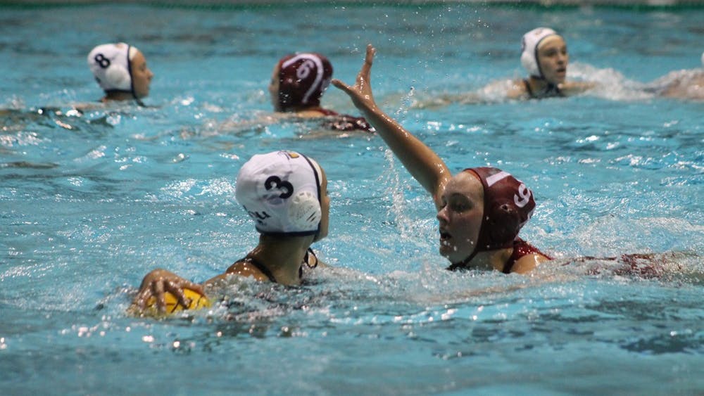California Baptist University sophomore, Lizette Perez, holds the ball away from IU junior Sarah Myers during the match-up Saturday. Myers finished the game with one goal and one assist helping the Hoosiers defeat the Lancer 13-6.