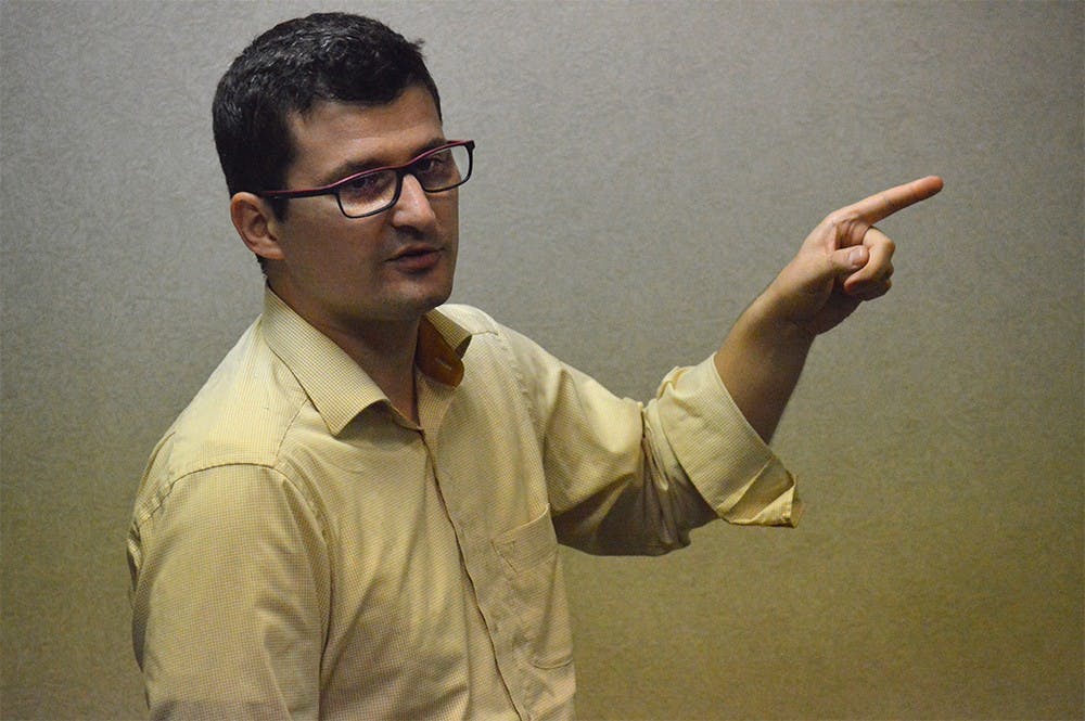 Csongor István Nagy Ph.D., an associate professor in Hungary, lectures on the efforts EU institutions have made to act as the guardians of human rights on Monday in the IMU Walnut Room.