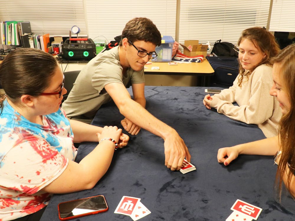 Kenzie Burgess, Reese Myers, Kacie Scales and Jada Collins play a game of euchre on Sept. 17, 2019, in Teter Quad. 