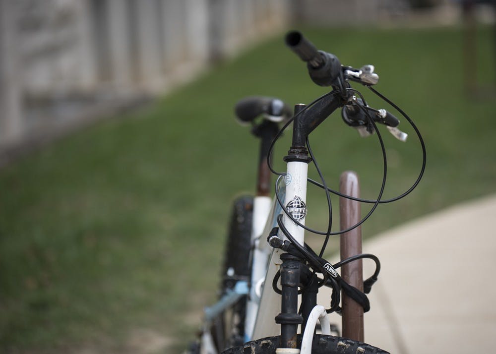 <p>A bike is attached to the rack Tuesday outside Franklin Hall. The City of Bloomington and IU are partnering to start a bike share program that will begin next year.&nbsp;</p>