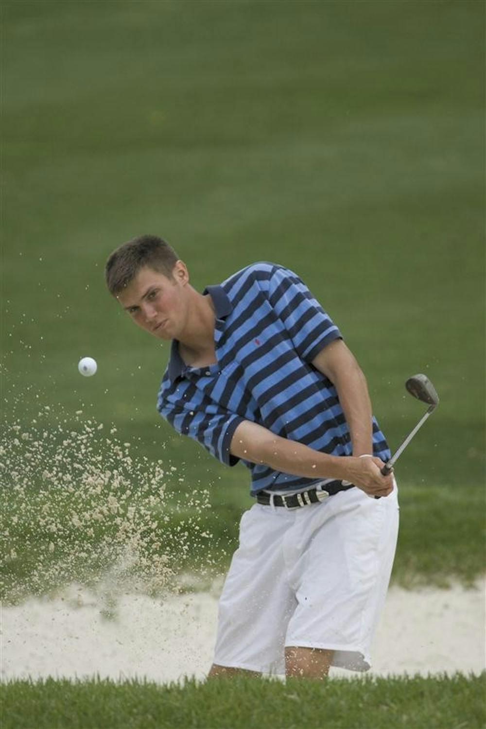 Golfer Jeff Overton practices hitting balls out of the sand trap Apr. 21, 2005, at the IU Public Golf Course. Overton has earned $3,456,356 in PGA Tour winnings this year, bringing his PGA career total to $7,126,953.