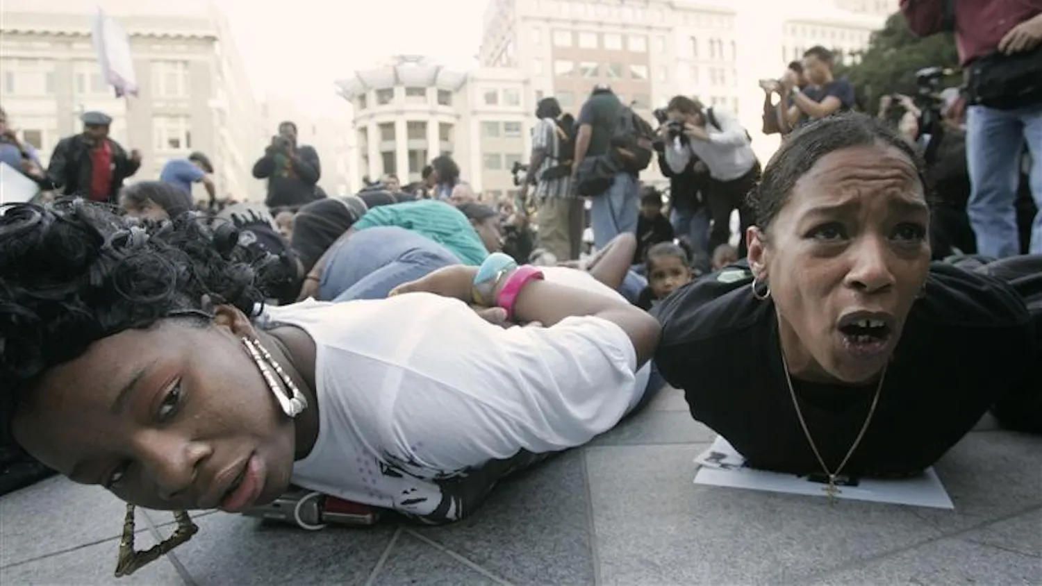 Protesters lie on the ground in a mock arrest pose during a protest against the shooting death of Oscar Grant in Wednesday in Oakland, Calif. A former transit police officer has been charged with murder for the fatal shooting of an unarmed and allegedly restrained black man in a racially charged case that has outraged residents and community leaders and set off violent protests.