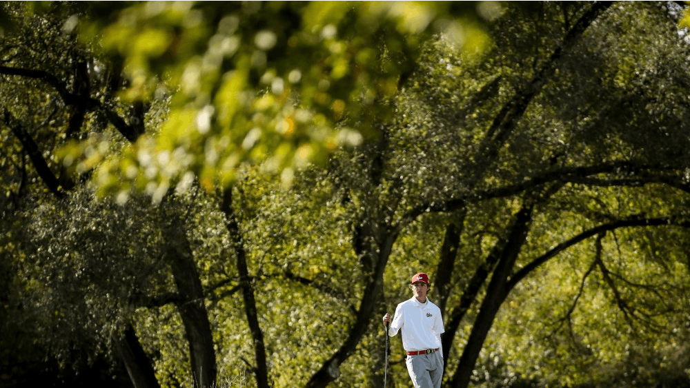 Junior Ethan Shepherd leans on a golf club Oct. 14 during the Crooked Stick Invitational at Crooked Stick Golf Course in Carmel, Indiana.