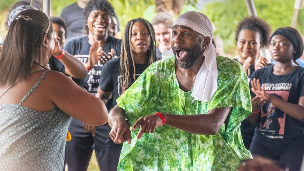Stafford Berry, African American Dance Company director, dances with someone from the audience Sept. 28, 2019, at the Lotus World Music and Arts Festival in Bloomington. The annual Lotus Festival will take place virtually this weekend, with the exception of one live, socially distanced concert at 1 p.m. Saturday at Switchyard Park. 