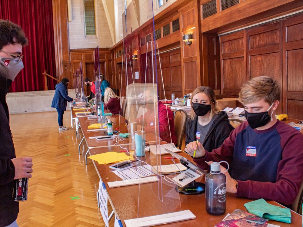Student Riley Knight helps a voter get checked in to vote Nov. 3, 2020, at the Indiana Memorial Union. Early voting for the primary election begins Tuesday, April 3, 2023, which allows voters to cast ballots for their preferred city council and mayoral candidates.