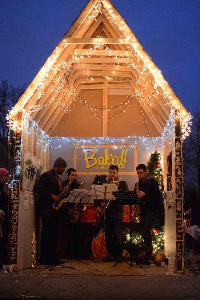 Locals of Bloomington decorate a record-breaking ginger bread house at Dunn Meadow on Saturday. This was a fundraising event, which raised over $1600, held by IU’s chapter of Habitat for Humanity. Daniel Nix, friend of Christina Zerfas, director of fundraising, grouped his friends together to perform at the event despite the cold weather.