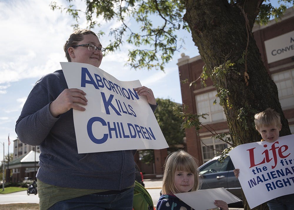 Amber Nikirk and her children Lily and Jeremiah hold pro-life signs on Oct. 1. Pro-life advocates like Nikirk won a major victory in June 2018 when the Supreme Court ruled in their favor in NIFLA v. Becerra&nbsp;