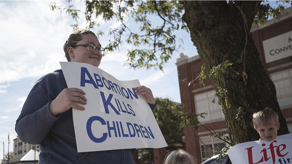 Amber Nikirk and her children Lily and Jeremiah hold pro-life signs on Oct. 1. Pro-life advocates like Nikirk won a major victory in June 2018 when the Supreme Court ruled in their favor in NIFLA v. Becerra&nbsp;