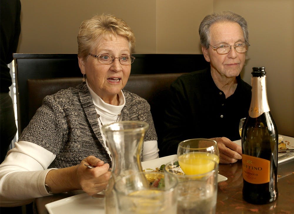 Brenda Lott, left, and Kendall Lott eat with a bottle of wine Saturday at Feast Bakery Cafe. Customers can drink wines at half price from Mar. 1 to Mar. 31. 
