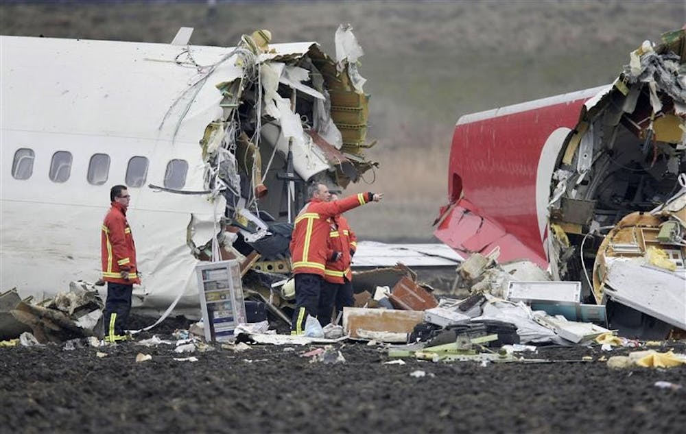 Rescue workers are seen near a Turkish Airlines plane which slammed into a field while attempting to land on Wednesday at Amsterdam's Schiphol Airport. A Turkish Airlines plane with 135 people aboard slammed into a muddy field while attempting to land at Amsterdam's main airport Wednesday. Nine people were killed and more than 50 were injured, many in serious condition, officials said.