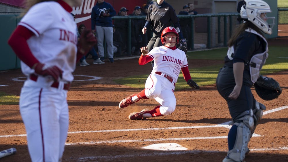 Senior Tatum Hayes slide into home plate to score a run March 28, 2023, at Andy Mohr Field. The win against Butler marks the Hoosiers sixteenth straight win.