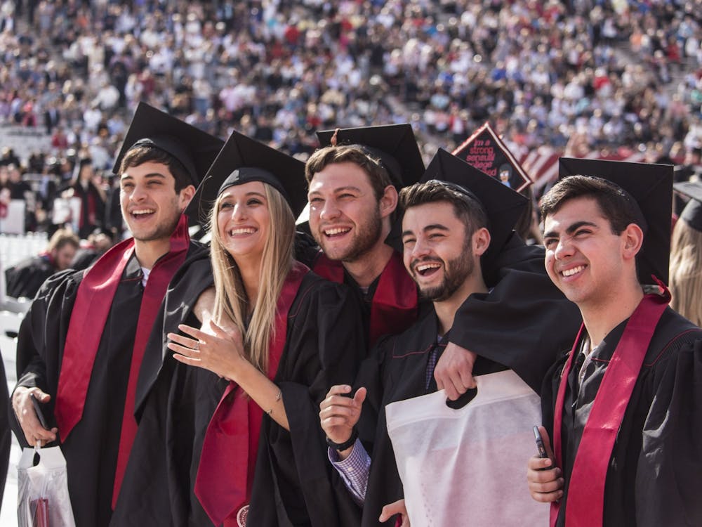 Members of the graduating class of 2018 pose for a group picture before the start of the undergraduate commencement May 5, 2018, in Memorial Stadium. IU’s deal with Herff Jones is making cap and gown costs higher for students compared to other Indiana colleges.