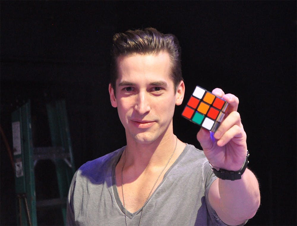 Max Major poses with a rubix cube, a prop he uses in his performance. His show "Think Again" will make its debut at the Bloomington Playwrighs Project Feb. 25-27.